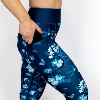 Kvinde i højtaljede mønstrede leggings. Tights har lommer på begge sider. Meget elastiske og squat proof.